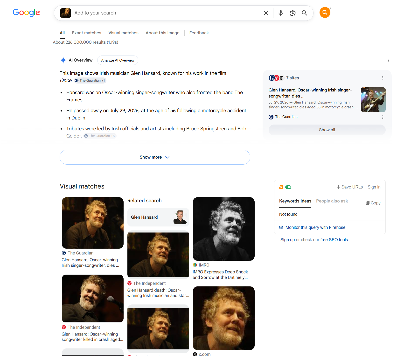 Google reverse-image search results identifying the photographed man as musician Glen Hansard, with an AI Overview summary, a related news result, and a 'Visual matches' row of similar photos.